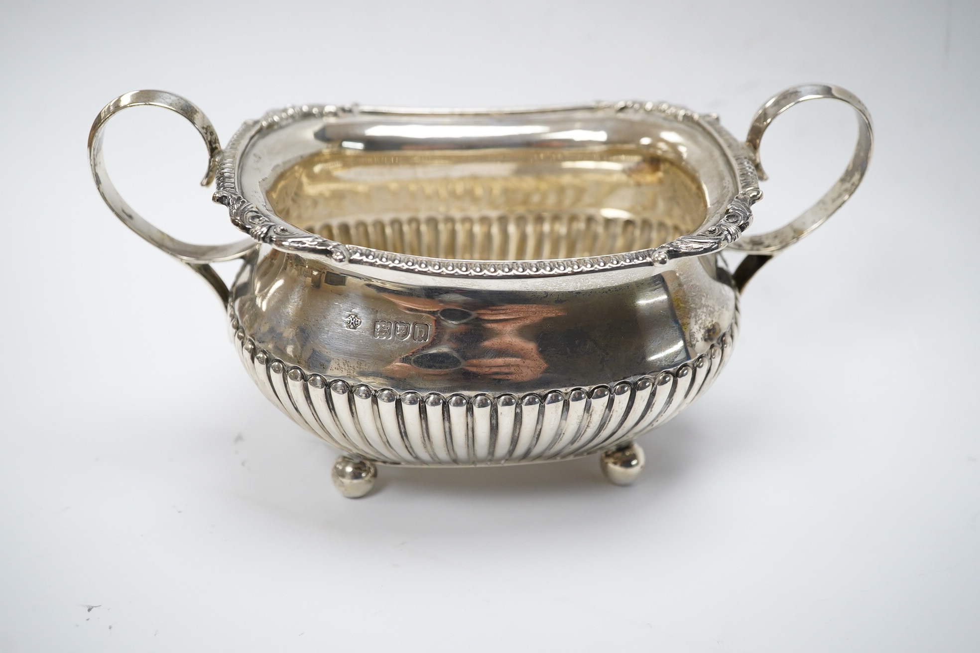 A late Victorian demi-fluted silver sugar bowl and a matching milk jug, by William Hutton & Sons, London, 1897, 12.6oz. Condition - good